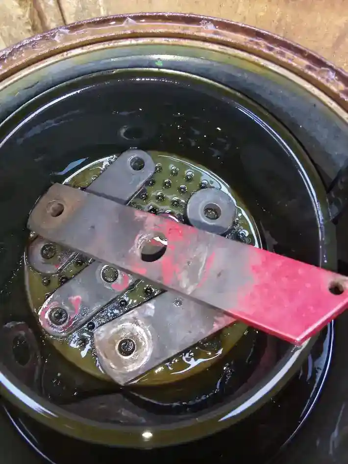 submersing tiller clutch linkage parts in chem dip for a soak